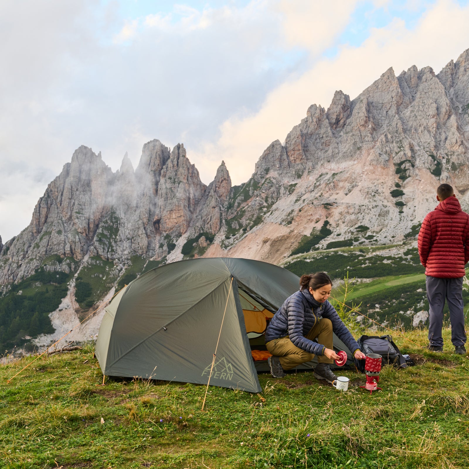 Fjern Gökotta tent pitched on a grassy plateau in the Dolomites overlooking a vast rocky ridgeline