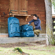 Fjern - Orädda 105L Wheeled Bag (Petrol) | The Orädda 105L Roller Duffle Bag is a rugged travel companion designed for durability
