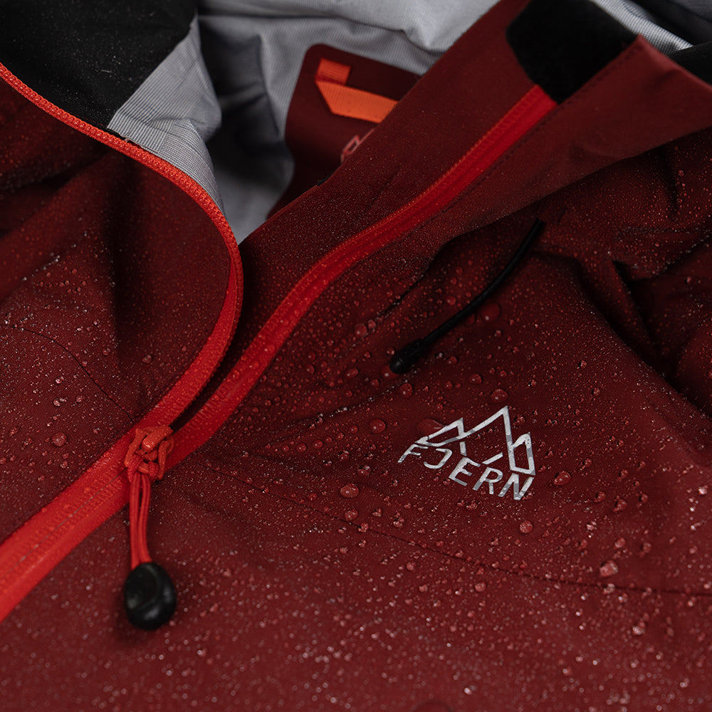 Fjern - Womens Orkan Waterproof Shell Jacket (Rust/Orange) | Face the harshest alpine challenges with confidence in the Orkan jacket, engineered to excel in extreme conditions