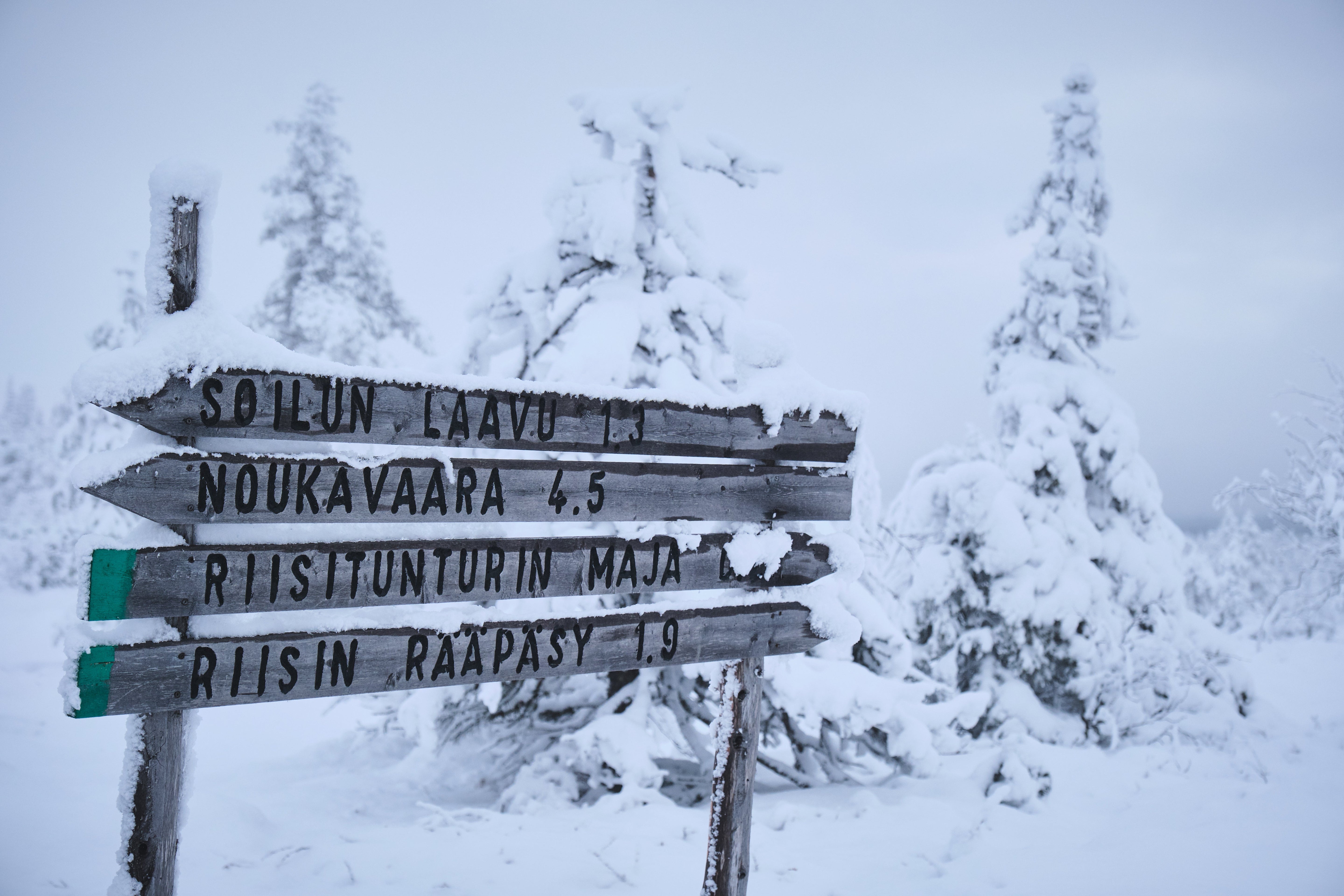 Direction sign in snowy Finish landscape