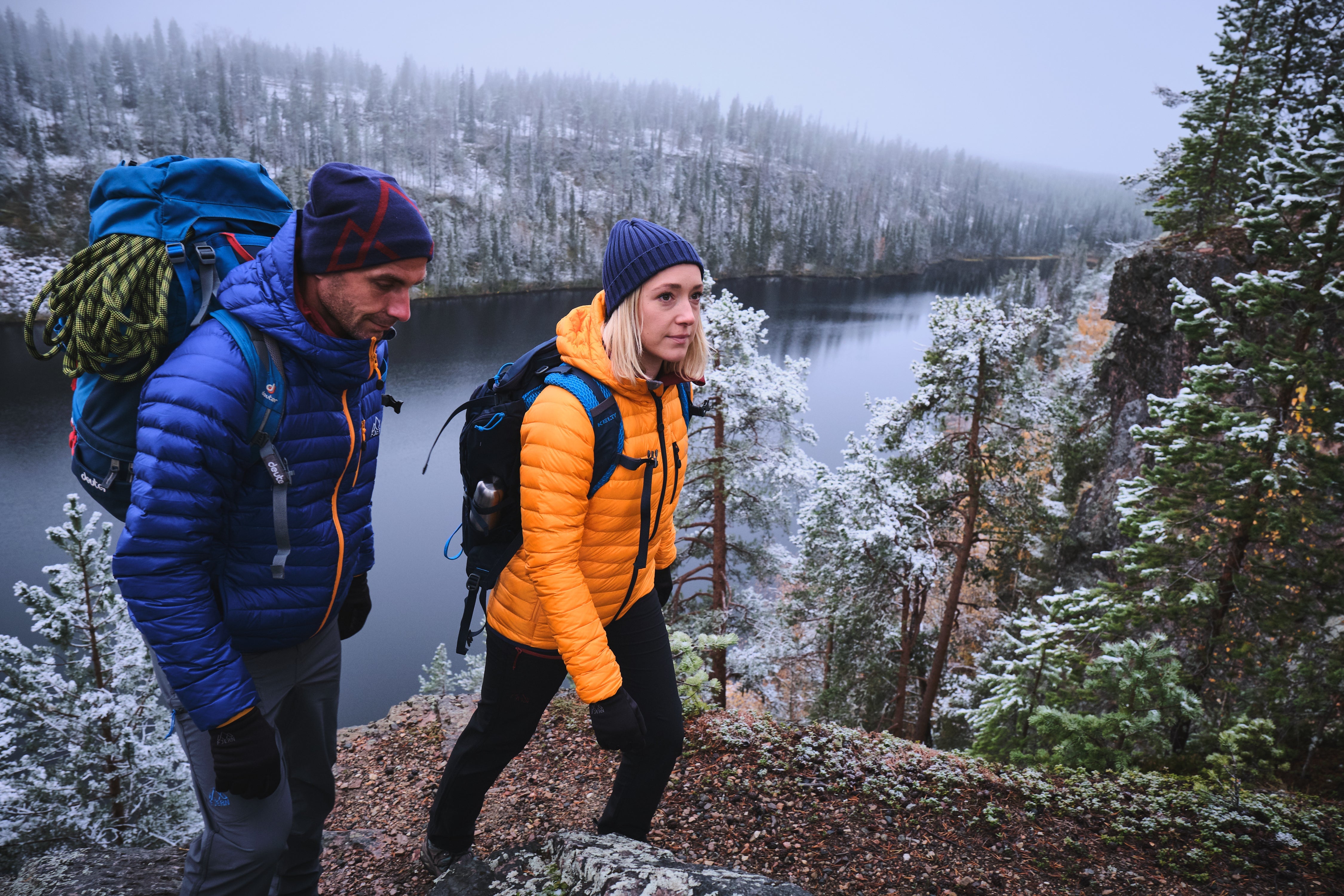 Aktiv Jackets worn on a snowy hilltop in Finland overlooking a wide river