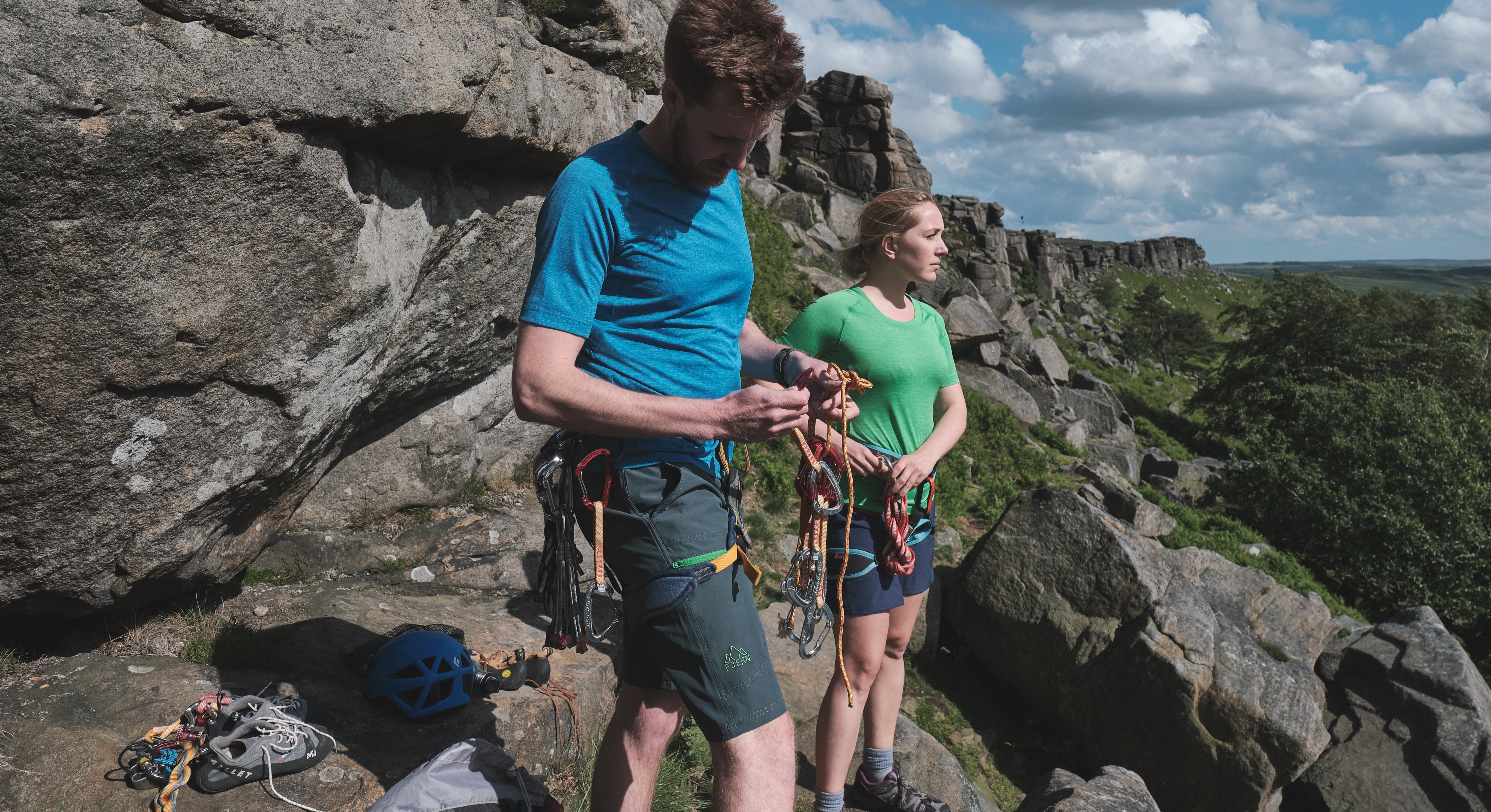 Klatring Shorts and Andas Crews being worn with harnesses in preparation for a rock climb
