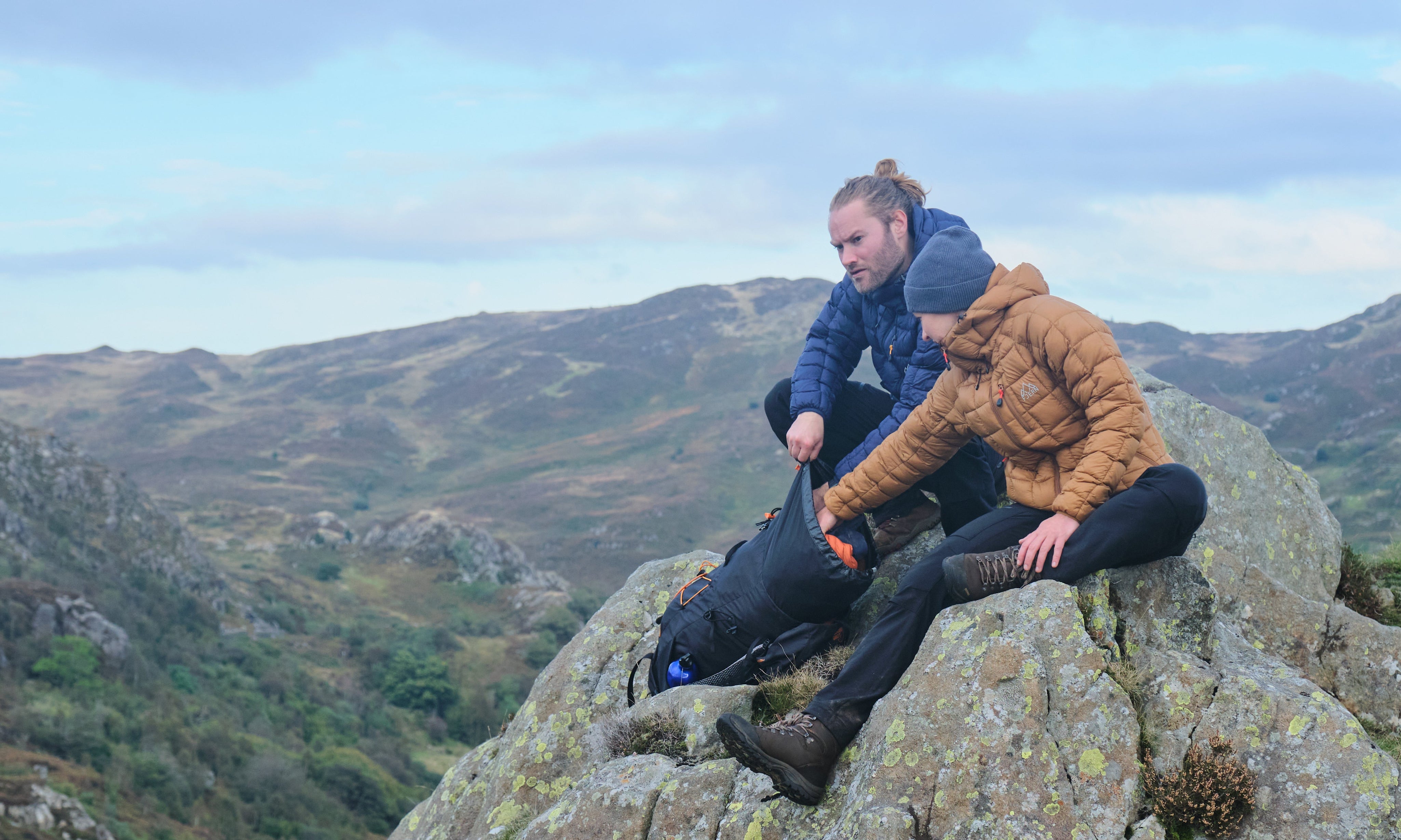 Fjern Eldur Insulated Jacket (Navy &amp; Mustard) on a large boulder