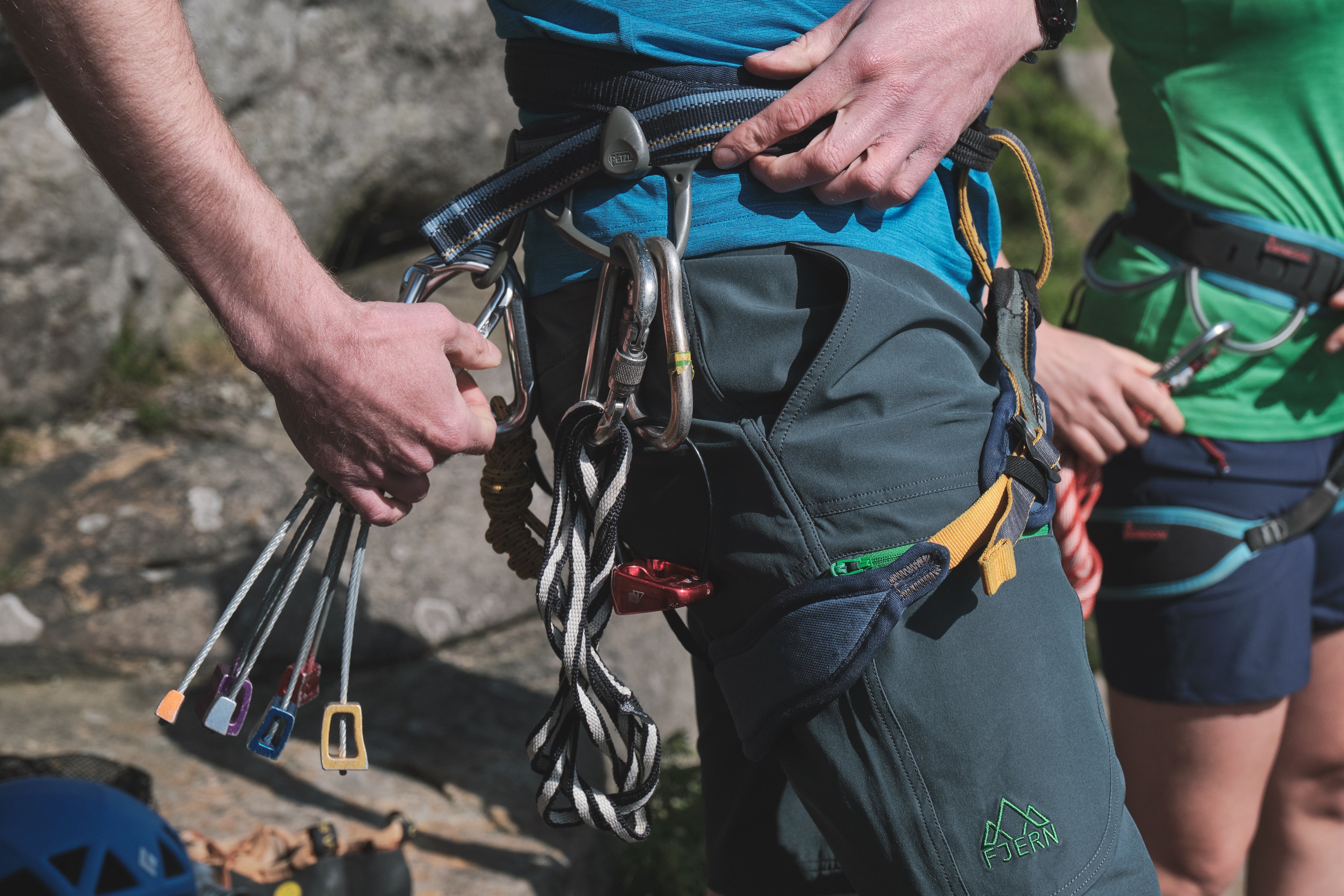 Closeup shot of Fjern Klatring Shorts with a harness and climbing attachments