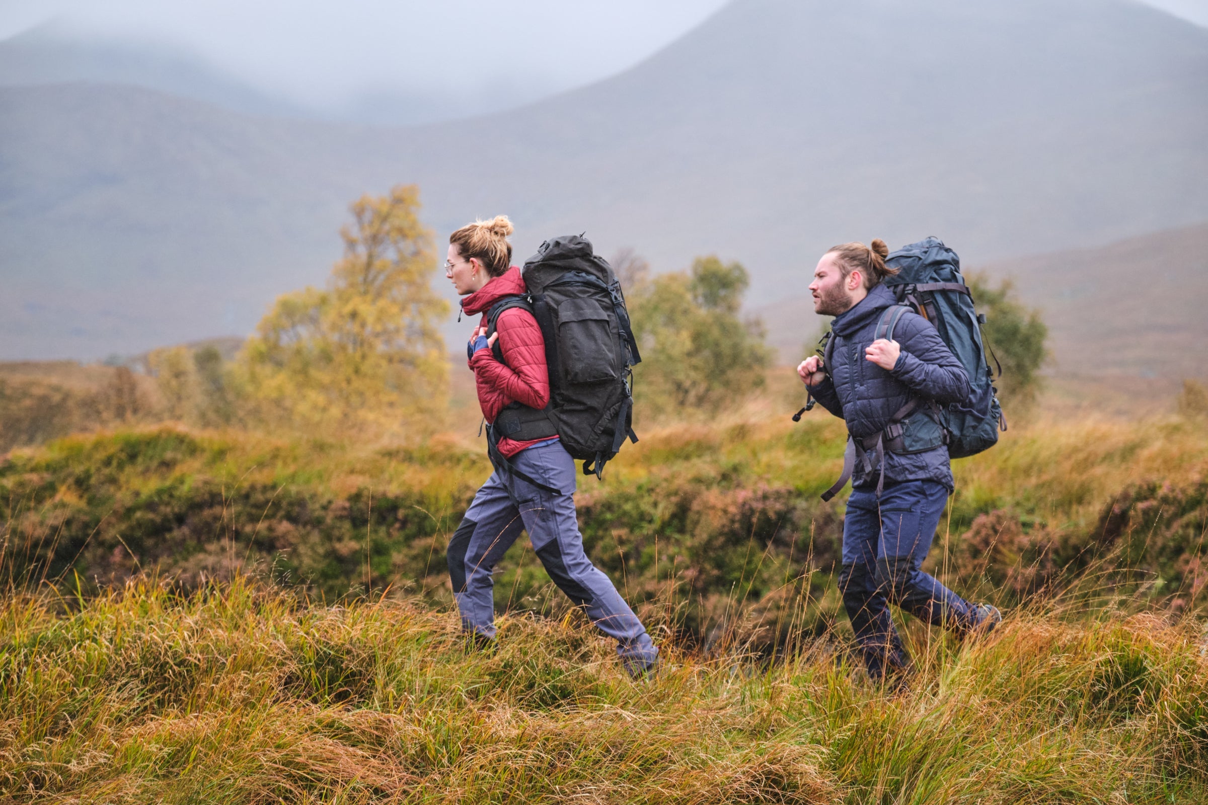 Fjern Skydda Packable Insulated Jacket worn with large rucksacks during a misty Highland hike