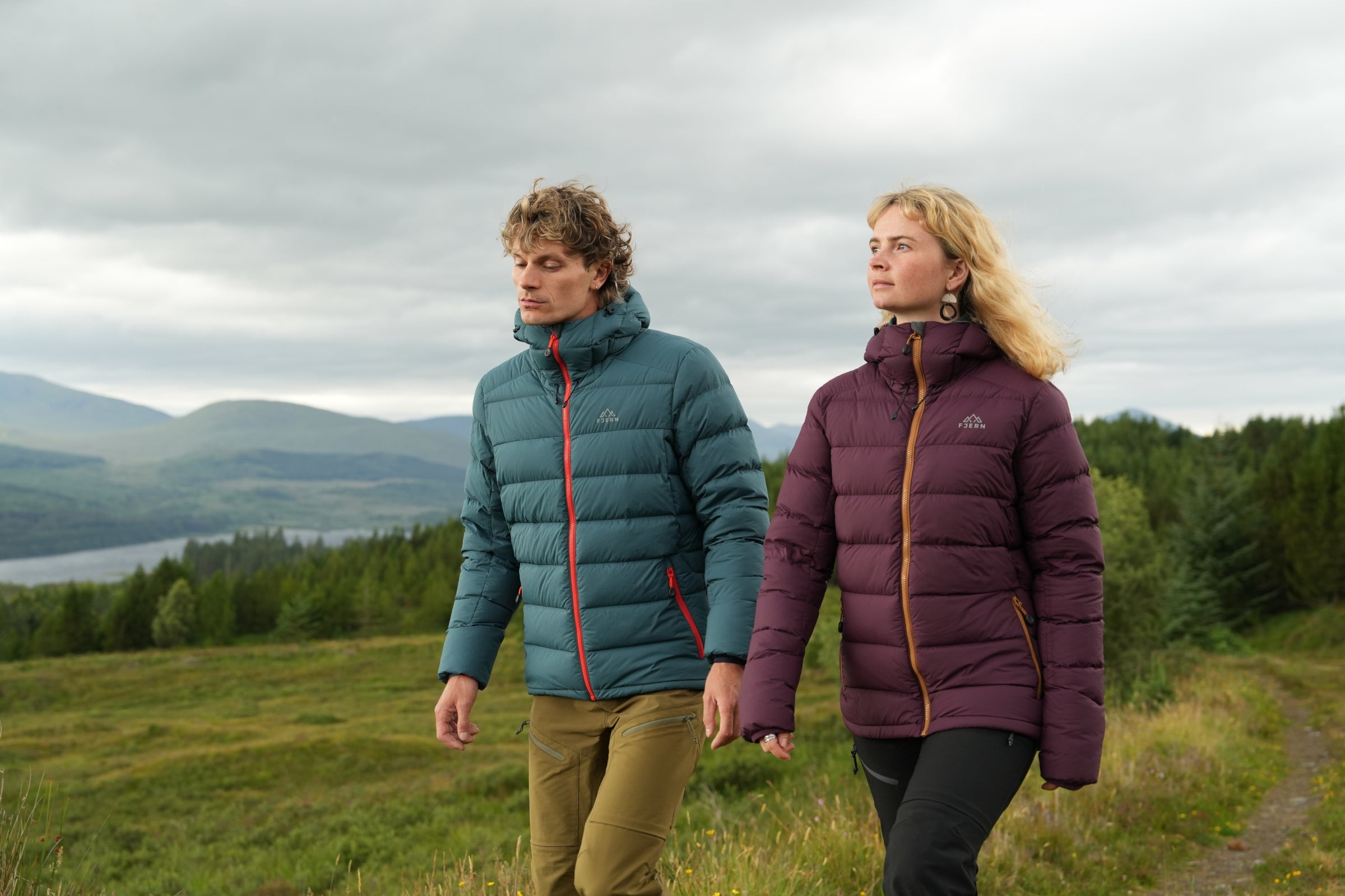 Two hikers wearing warm winter jackets in the hills