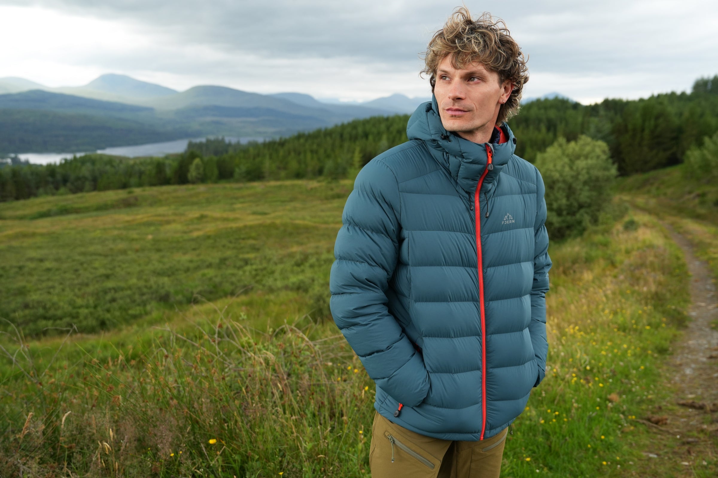 Man wearing Arktis III jacket outdoors in the hills