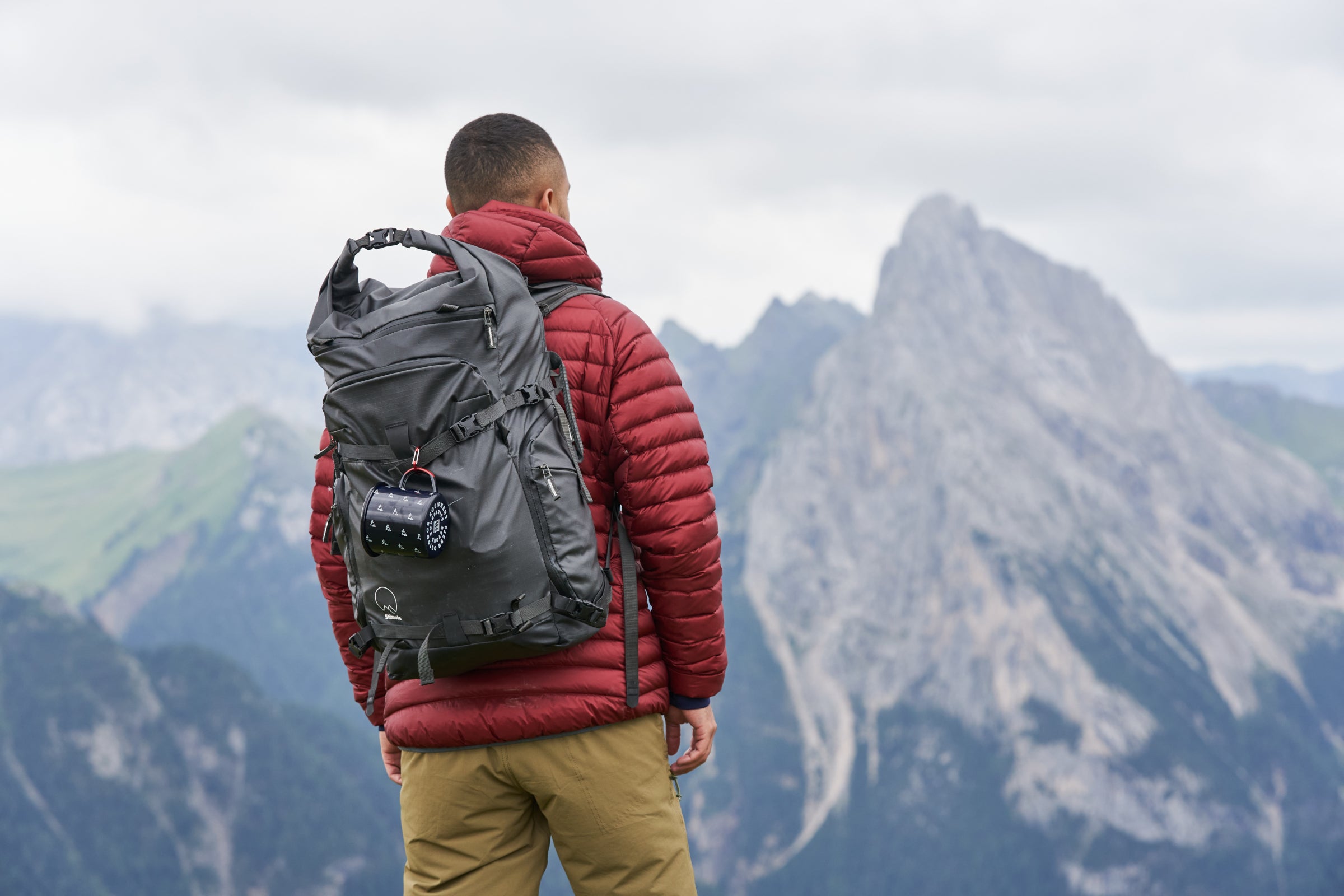 Hiker overlooking rugged mountain peaks