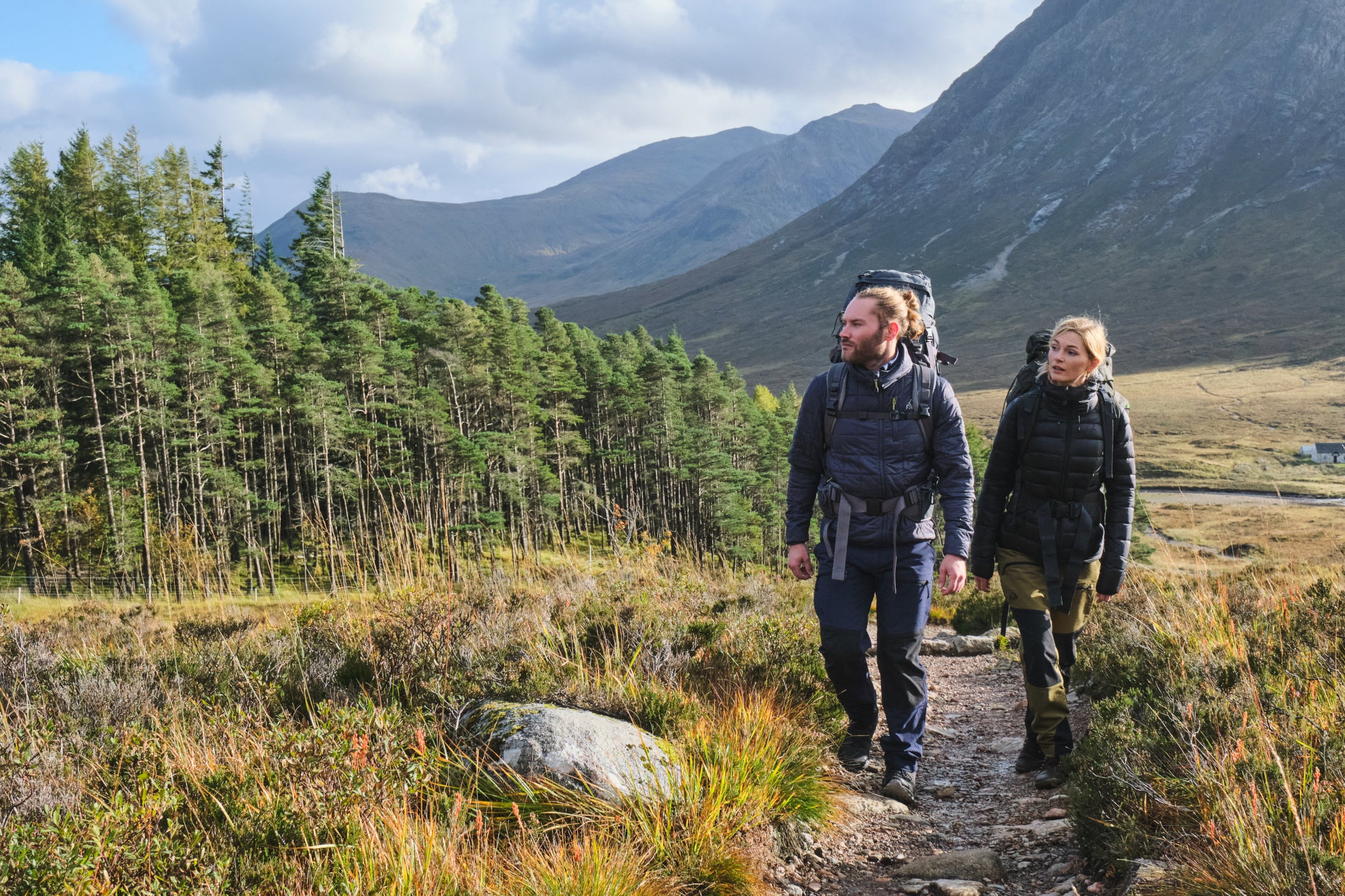 Two hikers in insulated jackets