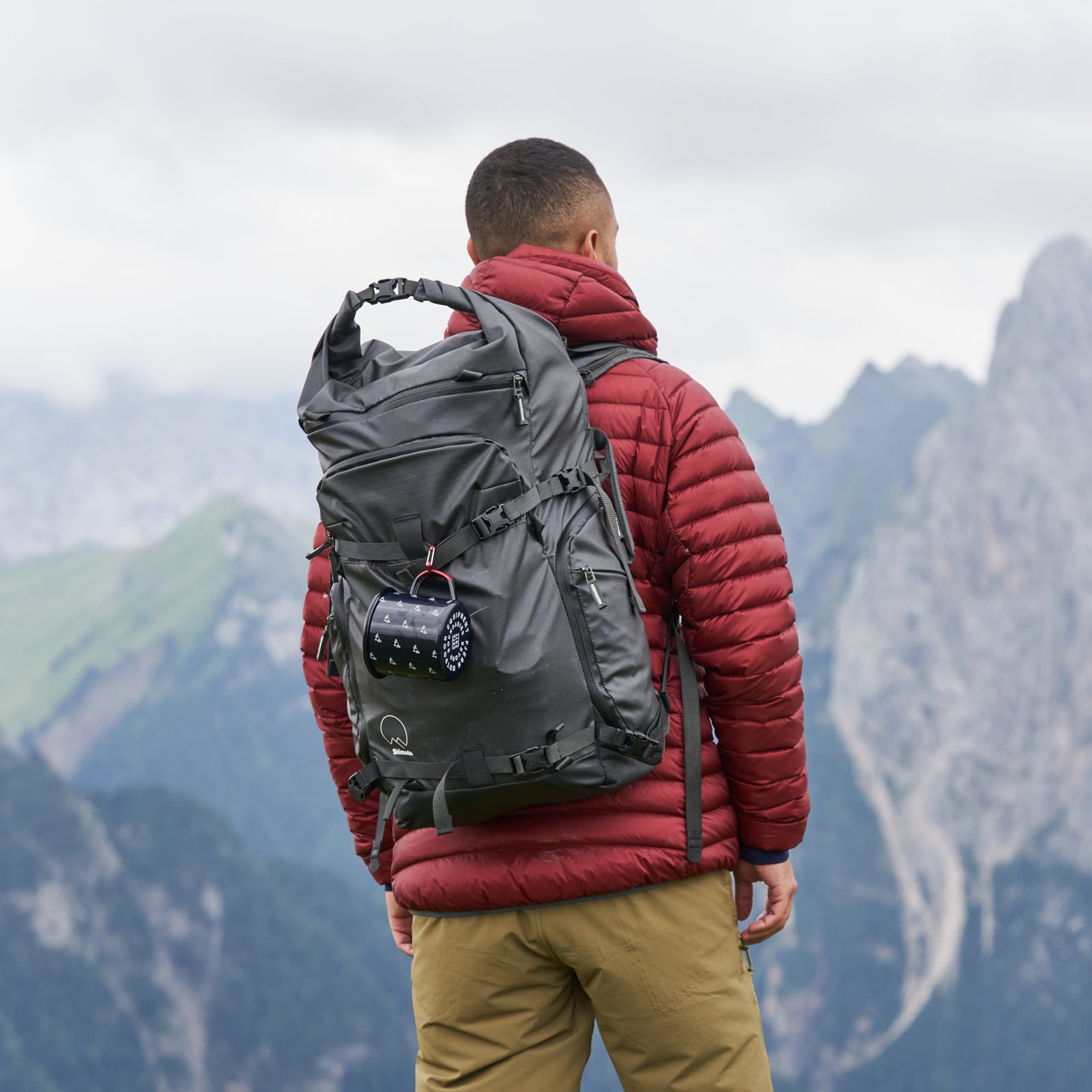Hiker overlooking rugged mountain peaks