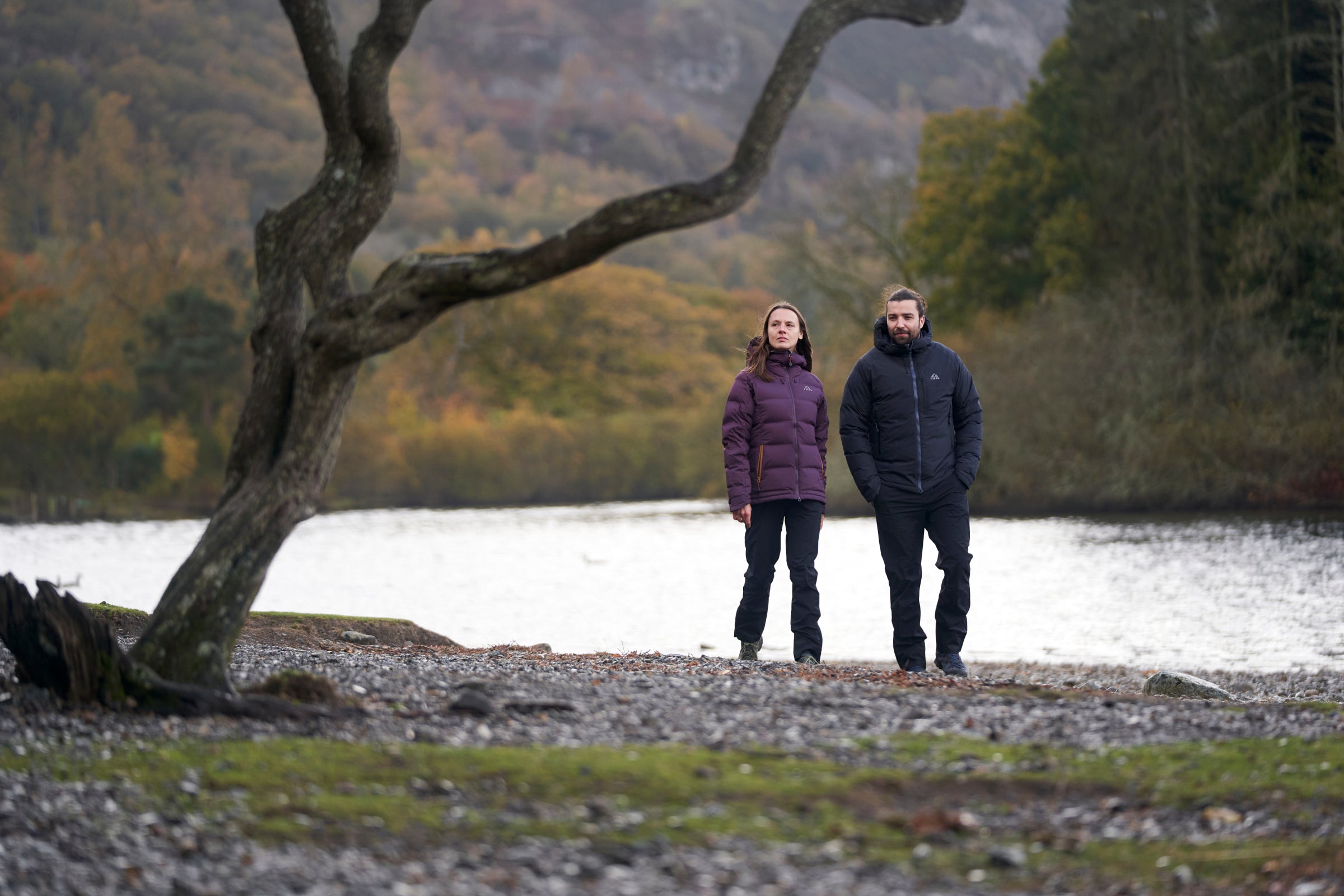 Two people in heavy insulated jackets by a lakeside