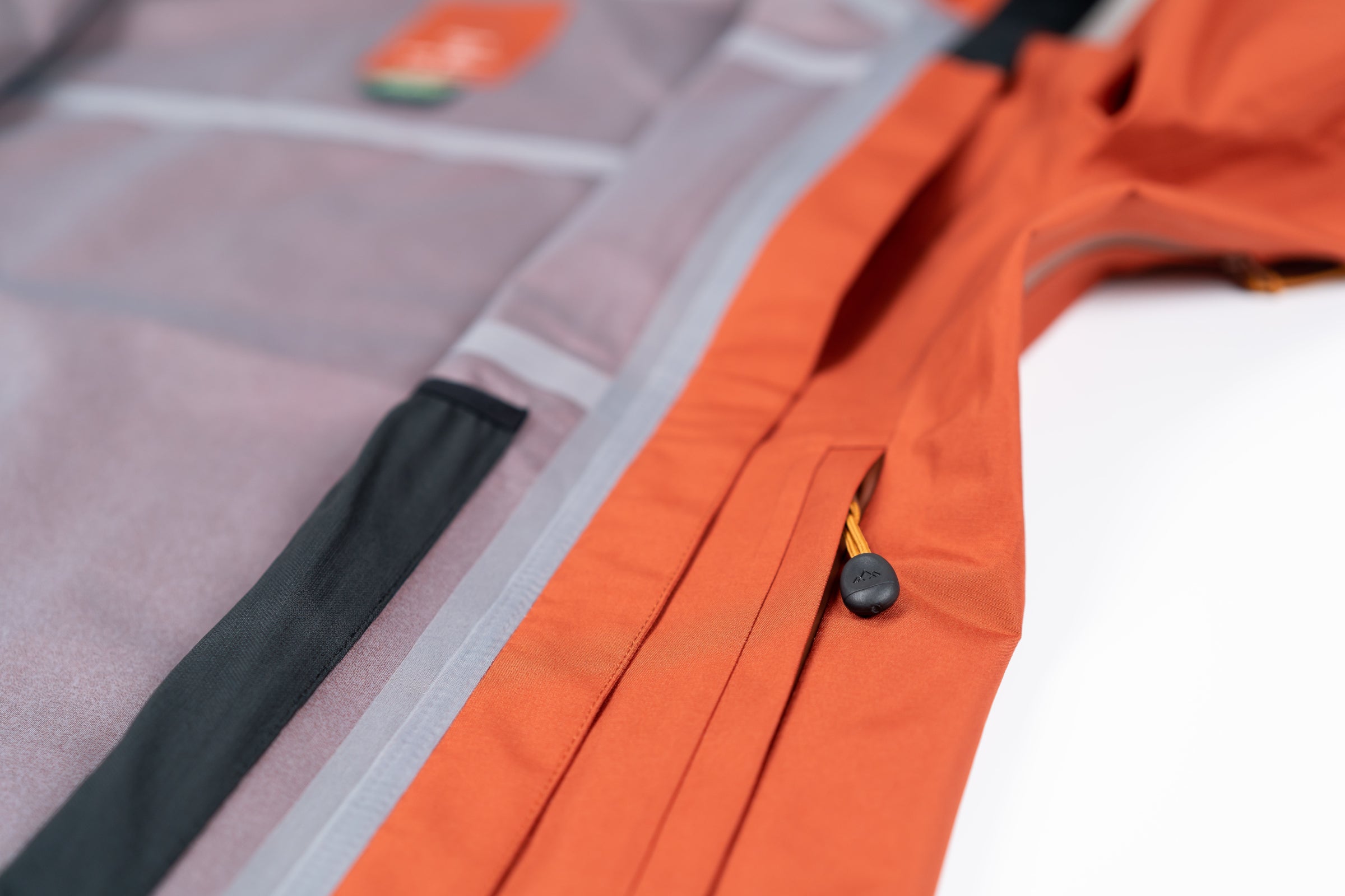 Close-up of waterproof jacket seam and pocket detail