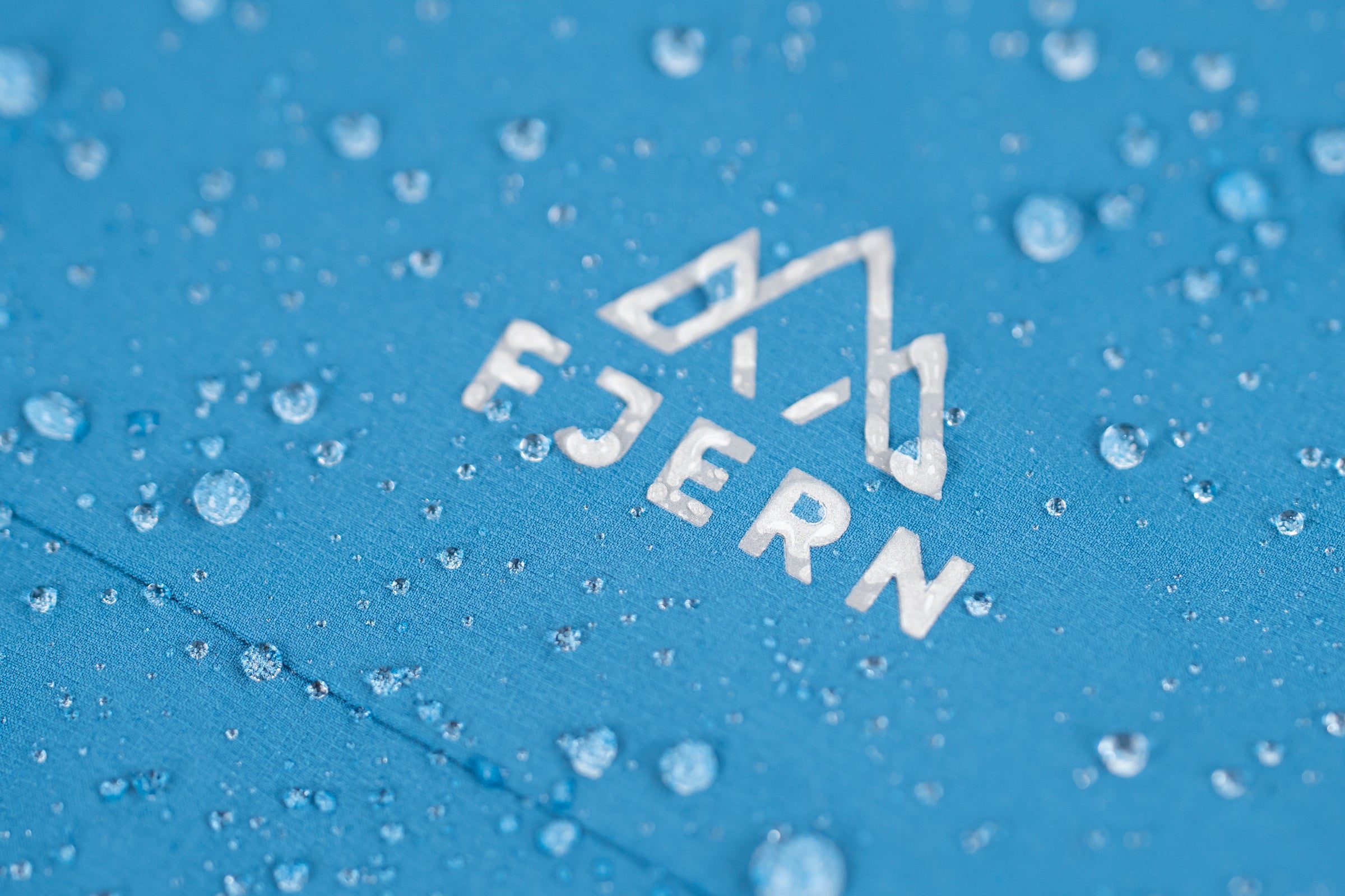 Water beading on blue Fjern waterproof jacket fabric