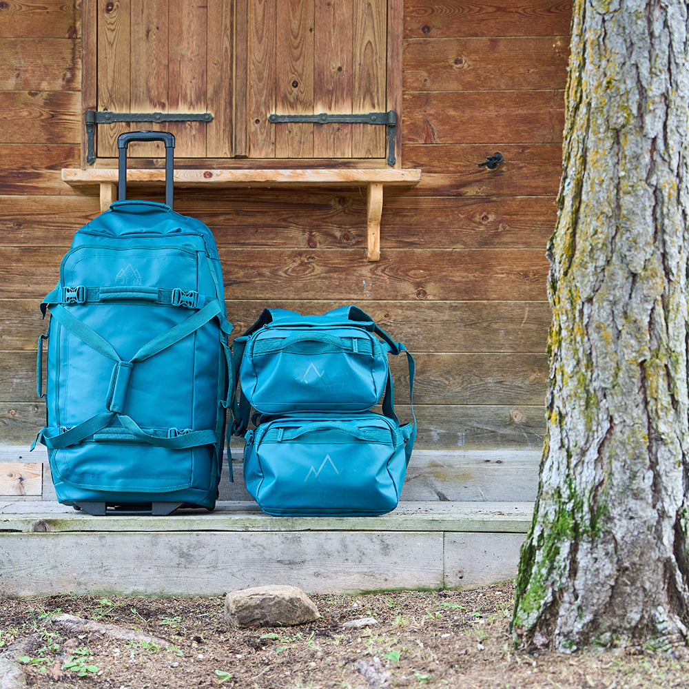 Fjern - Fördra 70L Duffle Bag (Petrol) | Made from durable 100% recycled polyester with a TPU-film laminate, the Fördra duffle bag offers 70L of storage, multiple pockets, and versatile carrying options
