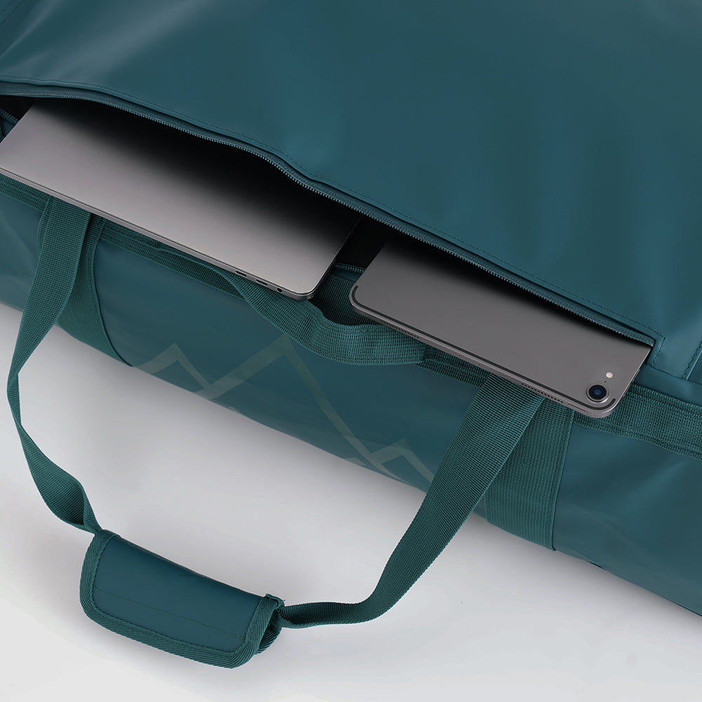 Fjern - Fördra 70L Duffle Bag (Petrol) | Made from durable 100% recycled polyester with a TPU-film laminate, the Fördra duffle bag offers 70L of storage, multiple pockets, and versatile carrying options