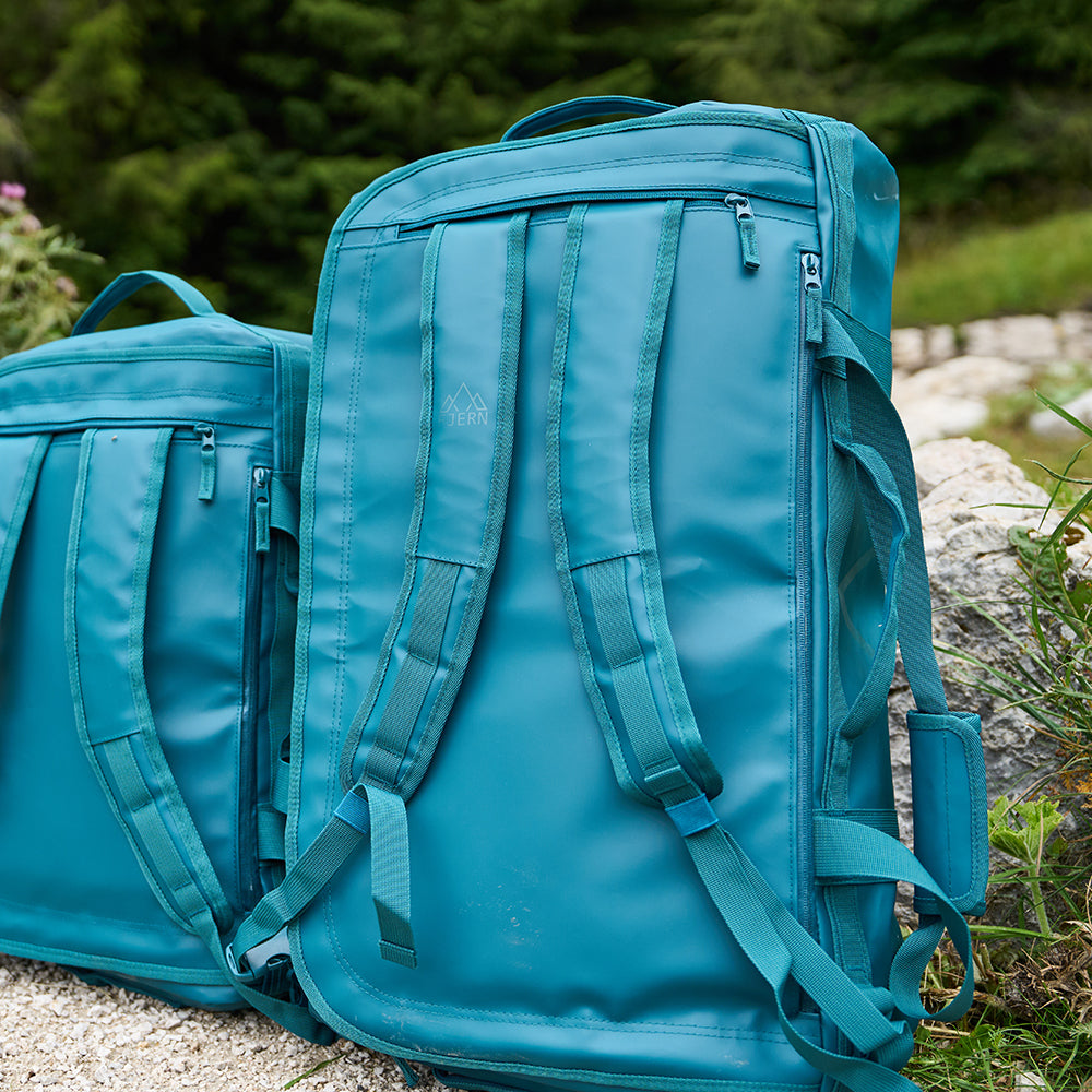 Fjern - Fördra 70L Duffle Bag (Petrol) | Made from durable 100% recycled polyester with a TPU-film laminate, the Fördra duffle bag offers 70L of storage, multiple pockets, and versatile carrying options