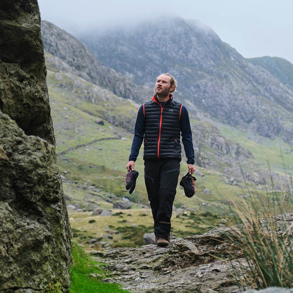 Orange) | Gear up your alpine performance with the Aktiv Gilet, a versatile and lightweight insulated layer that offers core warmth without the bulk