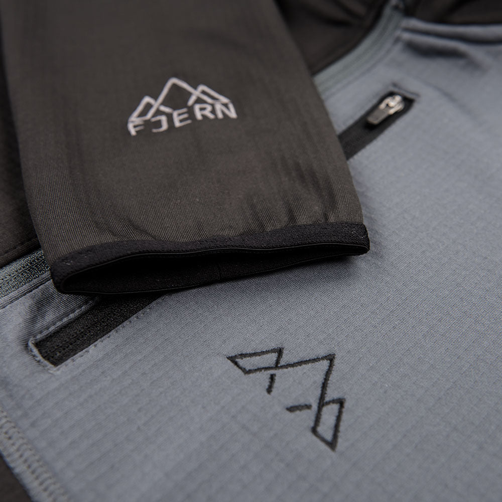 Fjern - Mens Bresprekk Half Zip Grid Fleece (Black/Charcoal) | Designed to meet the demands of ever-changing alpine conditions, the Bresprekk functions as both a winter baselayer and a lightweight midlayer