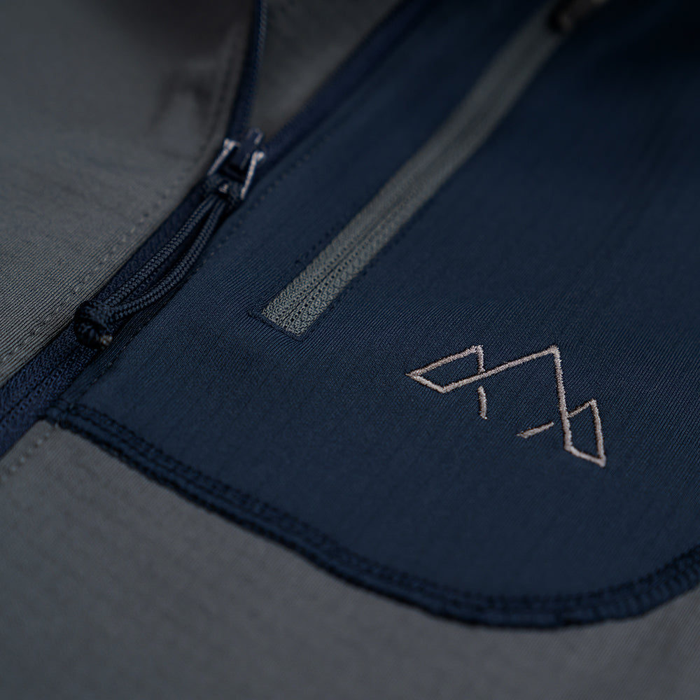 Fjern - Mens Bresprekk Half Zip Grid Fleece (Charcoal/Navy) | Designed to meet the demands of ever-changing alpine conditions, the Bresprekk functions as both a winter baselayer and a lightweight midlayer