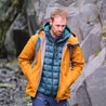 Fjern - Mens Forsvar Eco Waterproof Jacket (Mustard) | A testament to sustainable exploration, the Forsvar integrates planet-conscious waterproofing with a 15k/15k ecoSHIELD® fabric, crafted entirely from recycled polyester