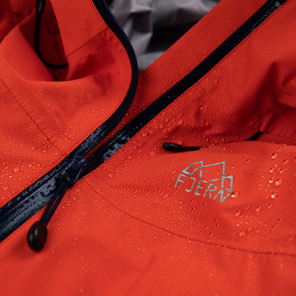 Fjern - Mens Orkan Waterproof Shell Jacket (Orange/Navy) | Face the harshest alpine challenges with confidence in the Orkan jacket, engineered to excel in extreme conditions