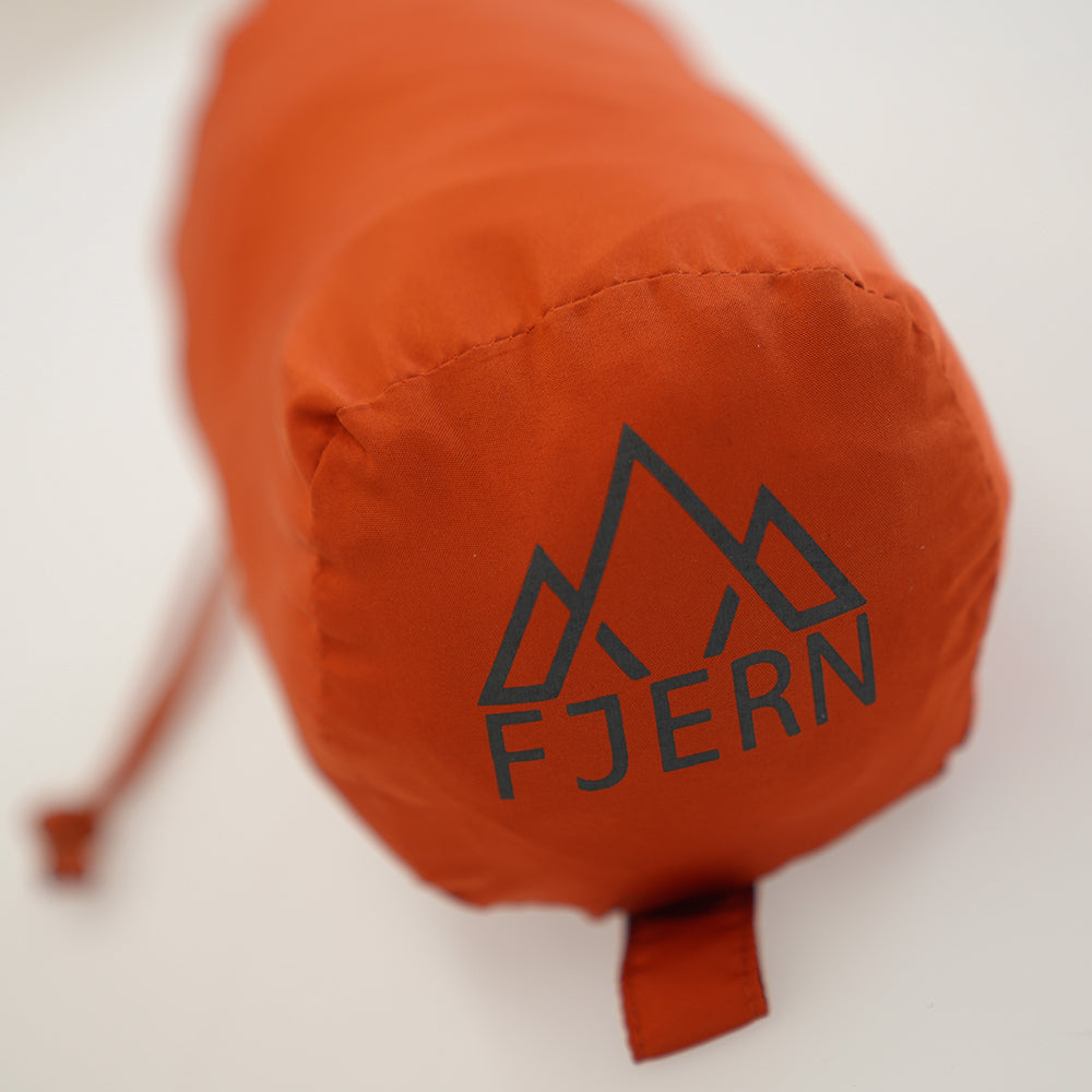 Fjern - Slumra Sleeping Bag Liner (Burnt Orange) | Made from 100% recycled polyester, this versatile liner boosts your sleeping bag's warmth in cool conditions and serves as a standalone bag for warm-weather camping or hostel stays