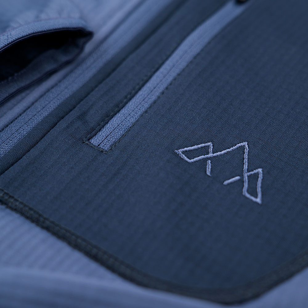 Fjern - Womens Bresprekk Full Zip Fleece (Indigo/Navy) | Designed for the unpredictable alpine conditions, the Bresprekk features Thermal Stretch Grid Fleece that offers exceptional warmth, breathability, and a comfortable fit