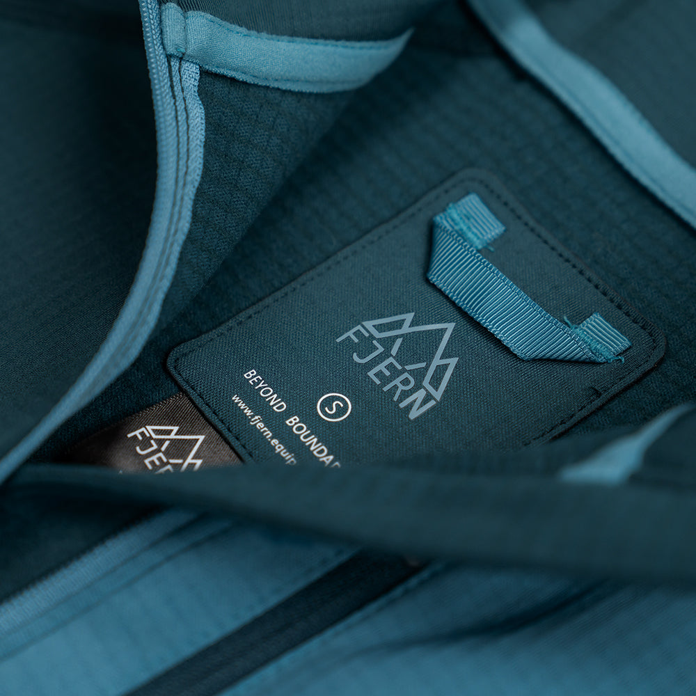Fjern - Womens Bresprekk Half Zip Grid Fleece (Petrol/Arctic Blue) | Designed to meet the demands of ever-changing alpine conditions, the Bresprekk functions as both a winter baselayer and a lightweight midlayer