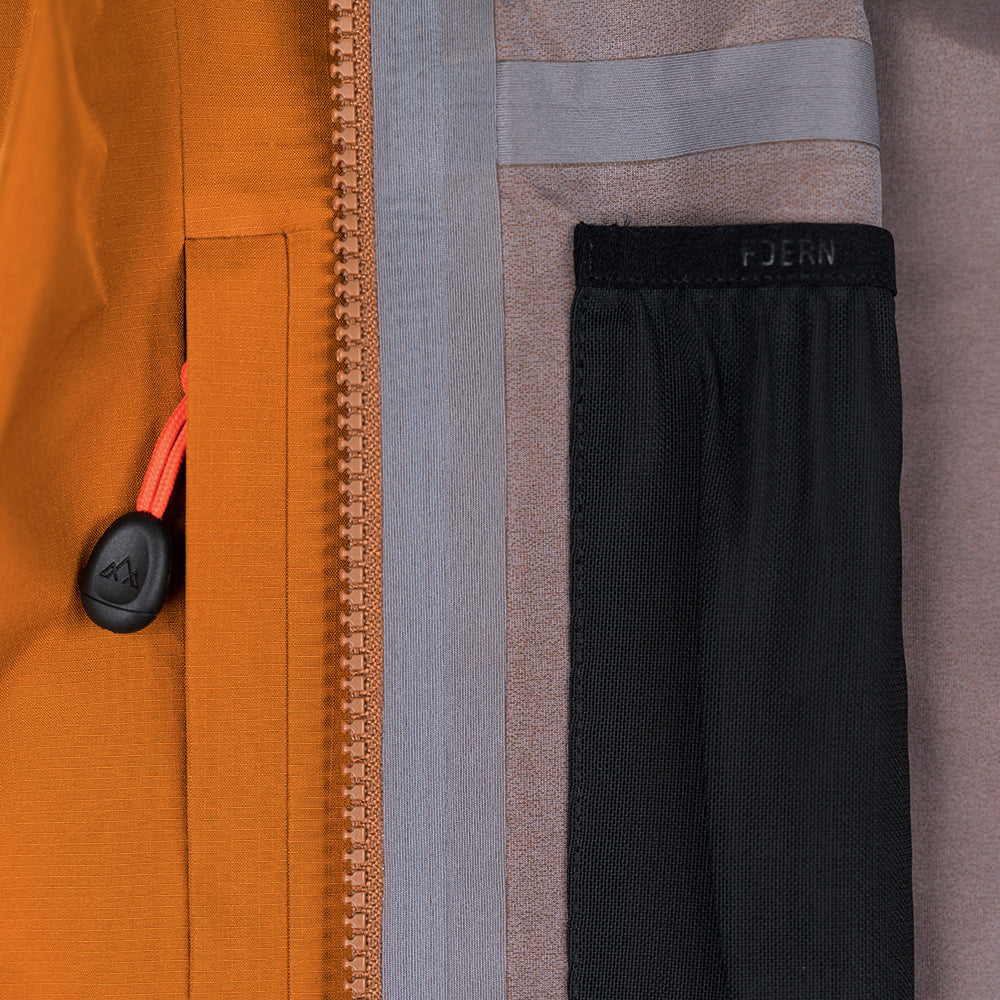Fjern - Womens Forsvar Eco Waterproof Jacket (Mustard) | A testament to sustainable exploration, the Forsvar integrates planet-conscious waterproofing with a 15k/15k ecoSHIELD® fabric, crafted entirely from recycled polyester