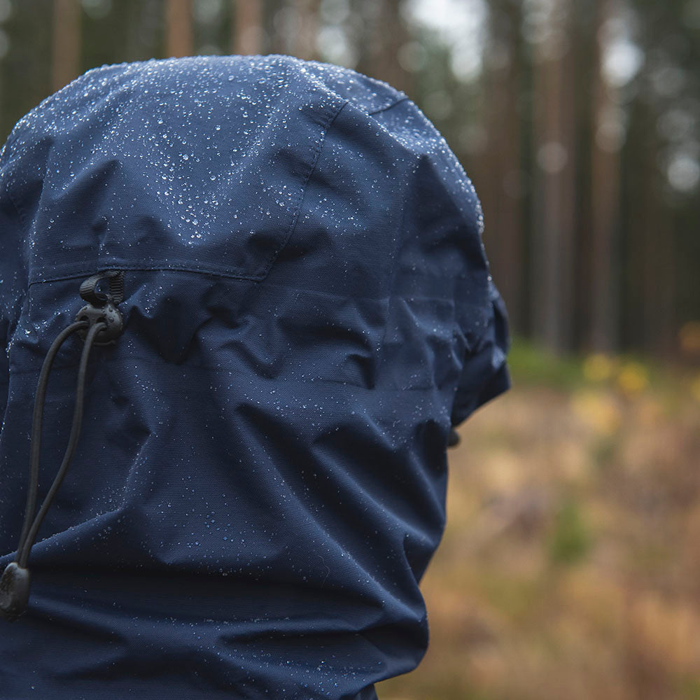 Fjern - Womens Orkan Waterproof Shell Jacket (Navy/Rust) | Face the harshest alpine challenges with confidence in the Orkan jacket, engineered to excel in extreme conditions