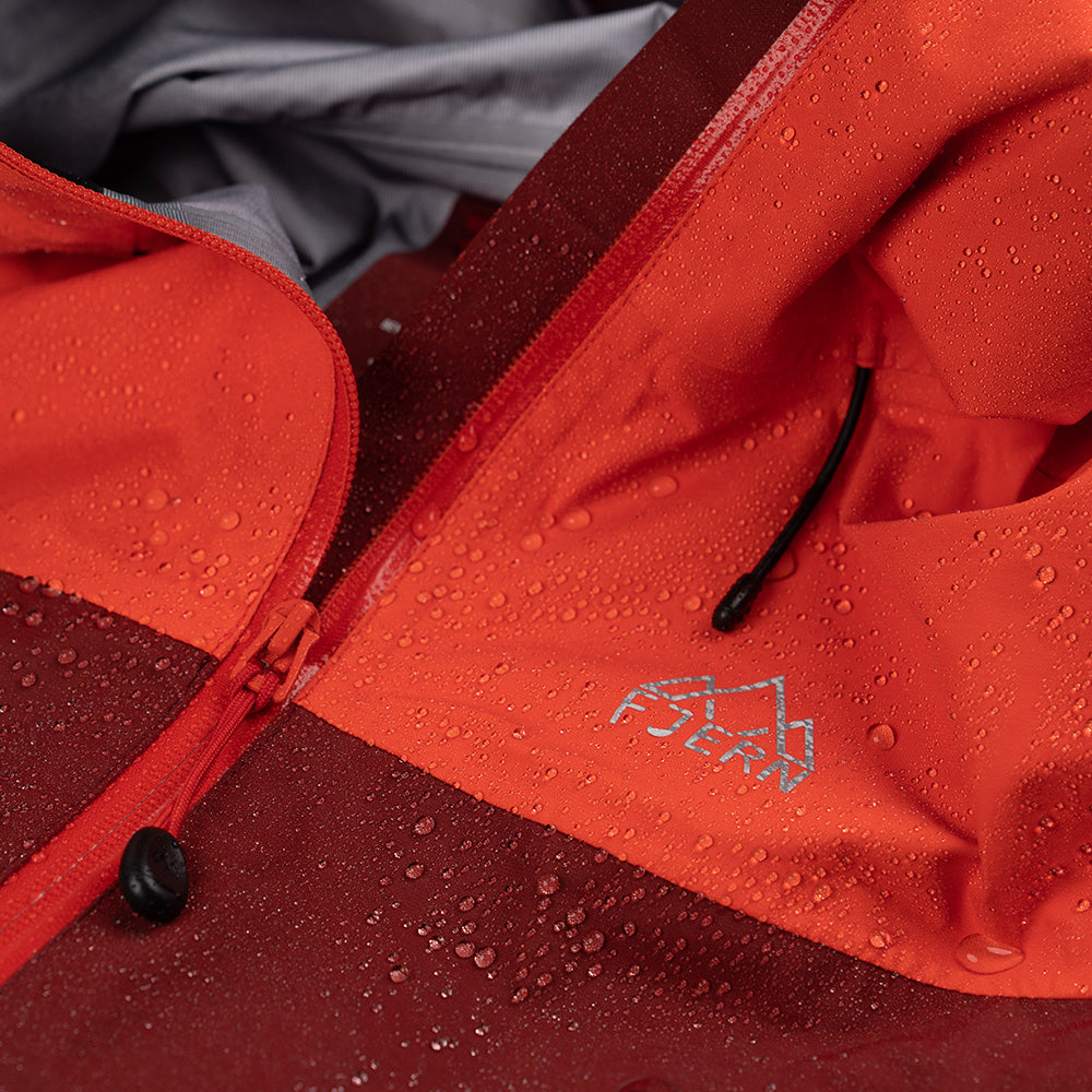 Fjern - Womens Orkan Waterproof Shell Jacket (Orange/Rust) | Face the harshest alpine challenges with confidence in the Orkan jacket, engineered to excel in extreme conditions